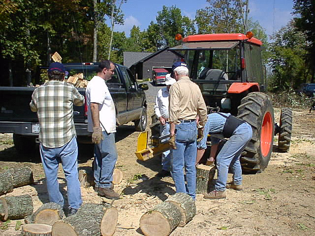 Project Crossroads volunteers cut firewood.